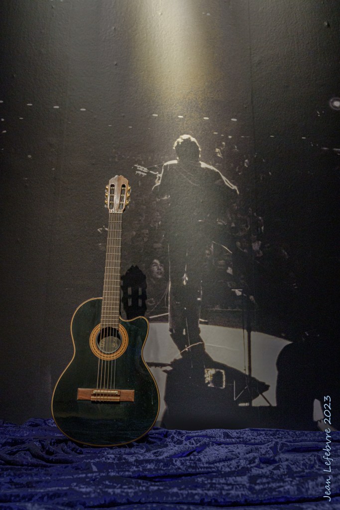 Guitar in front of Leonard Cohen photo
