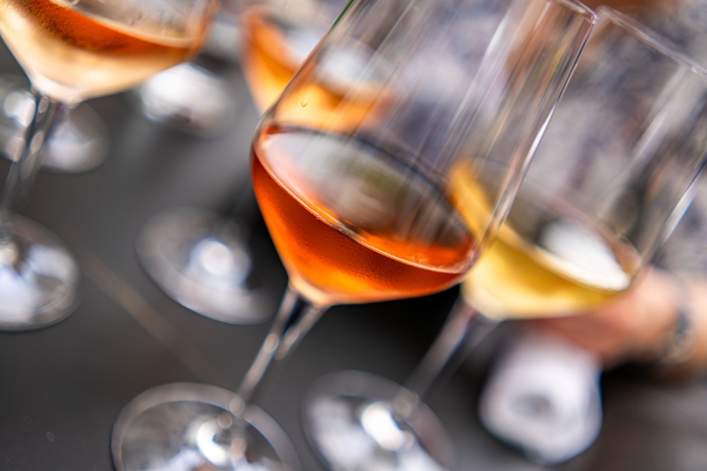 Close up of rose wine with others in the background.