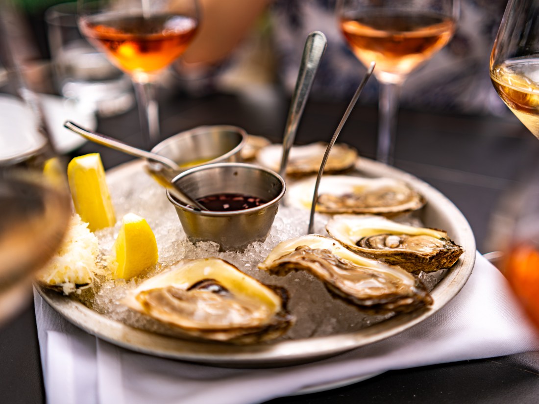 Oysters on ice with rose in the background.